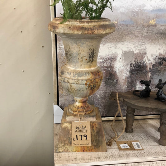 aged pedestal urn